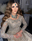 A woman wearing a Scarlet Bridal Set which includes a necklace, earrings, and a tikka.