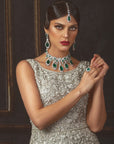 A woman wearing a Scarlet Bridal Set which includes a necklace, earrings, and a tikka.