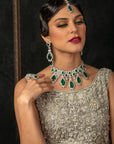 A woman wearing a Scarlet Bridal Set which includes a necklace, earrings, and a tikka.